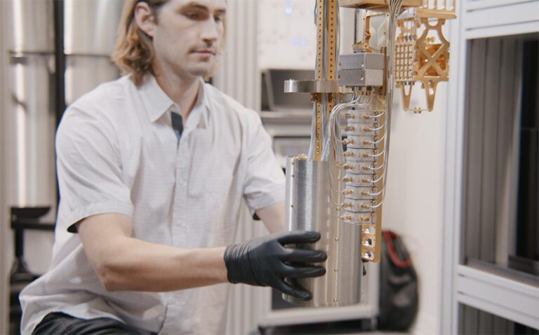 Image 3 - An AWS engineer installs magnetic shielding around a quantum processor prior to testing at the AWS Center for Quantum Computing in Pasadena, Calif. Credit_ AWS