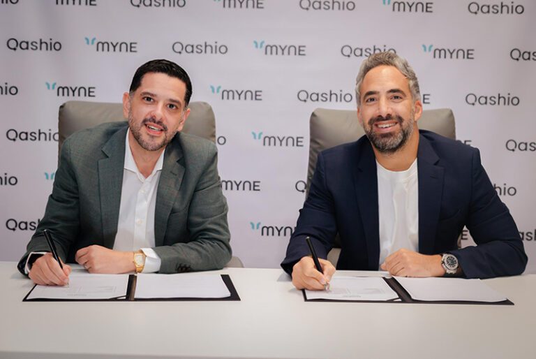 Image - Armin Moradi, CEO and Co-Founder of Qashio, signing the partnership with Karim Chouman, CEO of Myne.